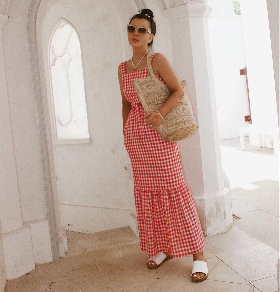Woman wears gingham maxi dress with frill from Marks & Spencer