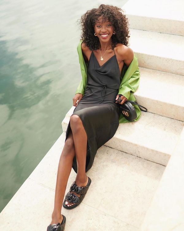 emmanuellek_ wearing a black slip dress, a green blazer and chunky black sandals