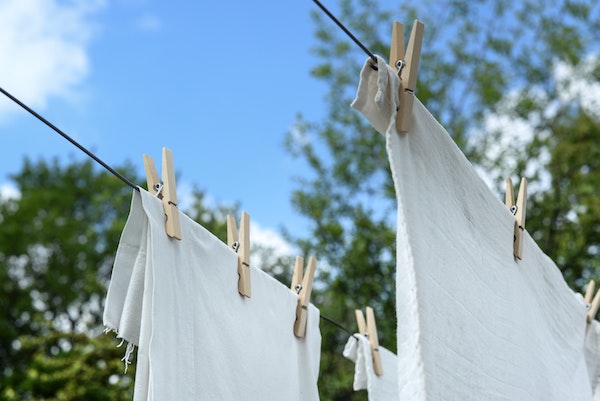white tea towels and laundry hanging up on a washing line