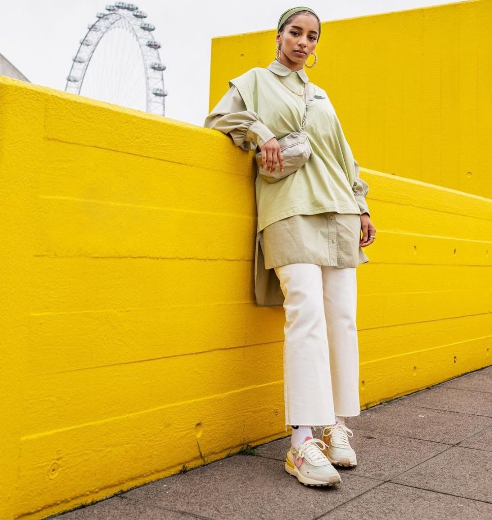 @guapacita_ wearing a headscarf, layered shirts, jeans and trainers