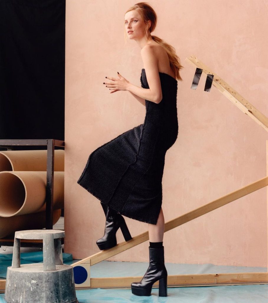 model wears black platform boots and a black dress from zara