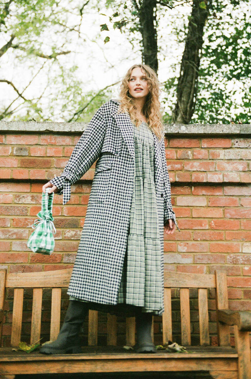 Model Isabella Lilley at Wilhelmina Models wearing Coat, JunLi; dress, Ghospell; boots, as before; bag, Kit-a.