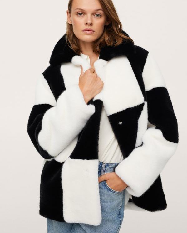 woman wears faux fur checkerboard coat from mango