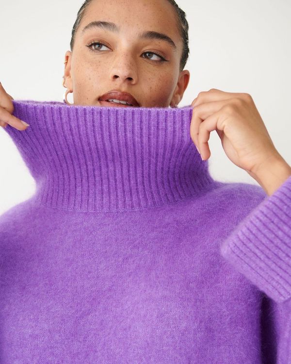Model wearing purple wool turtleneck