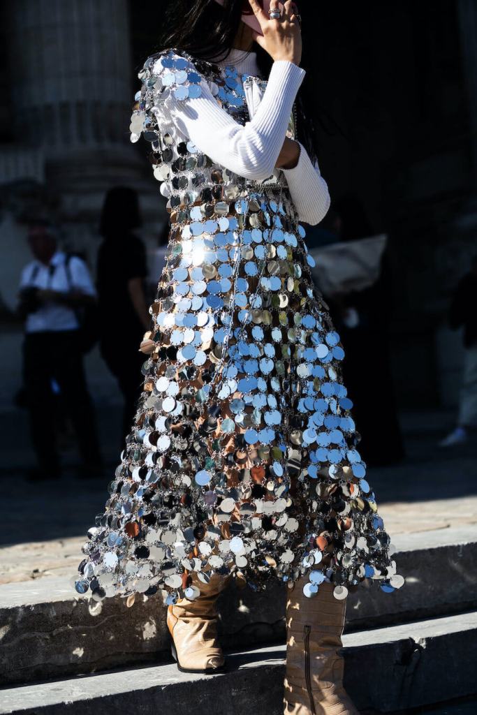 woman wears sequin dress at paris fashion week