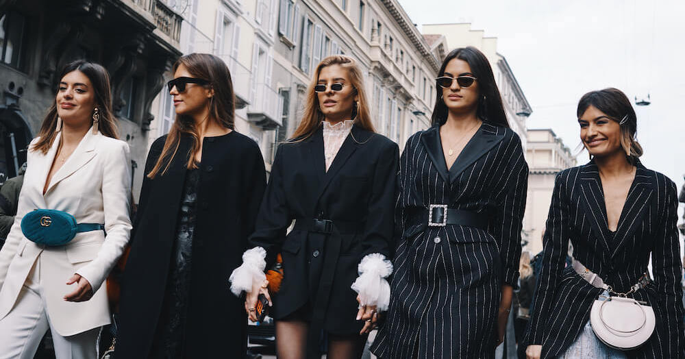 5 women in black at fashion week