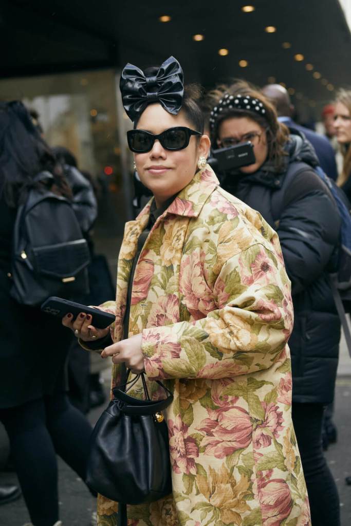 woman at london fashion week wearing a floral print coat