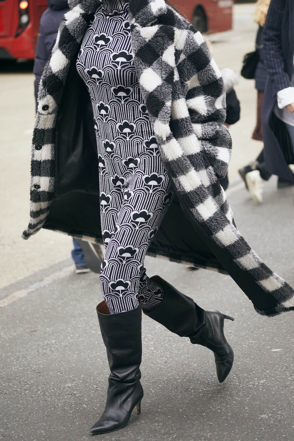 woman wears prada catsuit at london fashion week