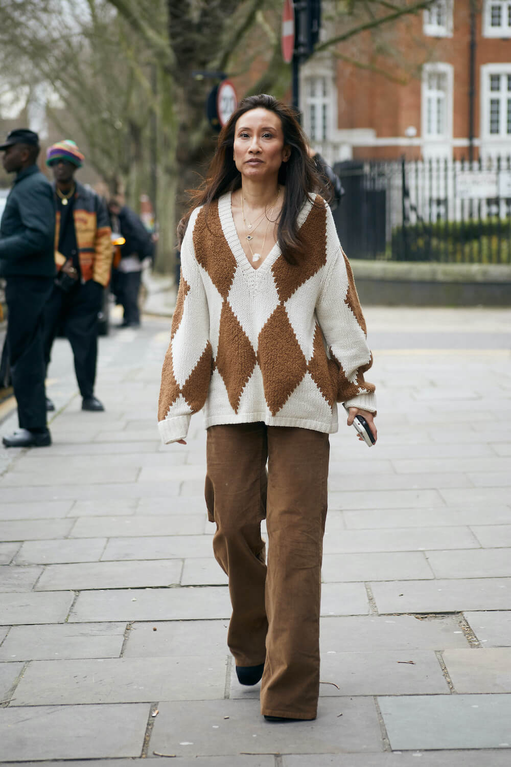 woman wears brown corduroy pants at london fashion week