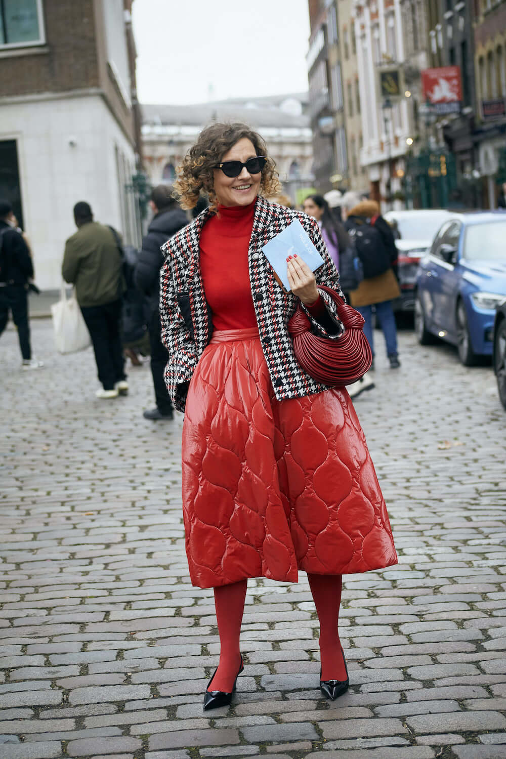 woman wears quilted red skirt at london fashion week