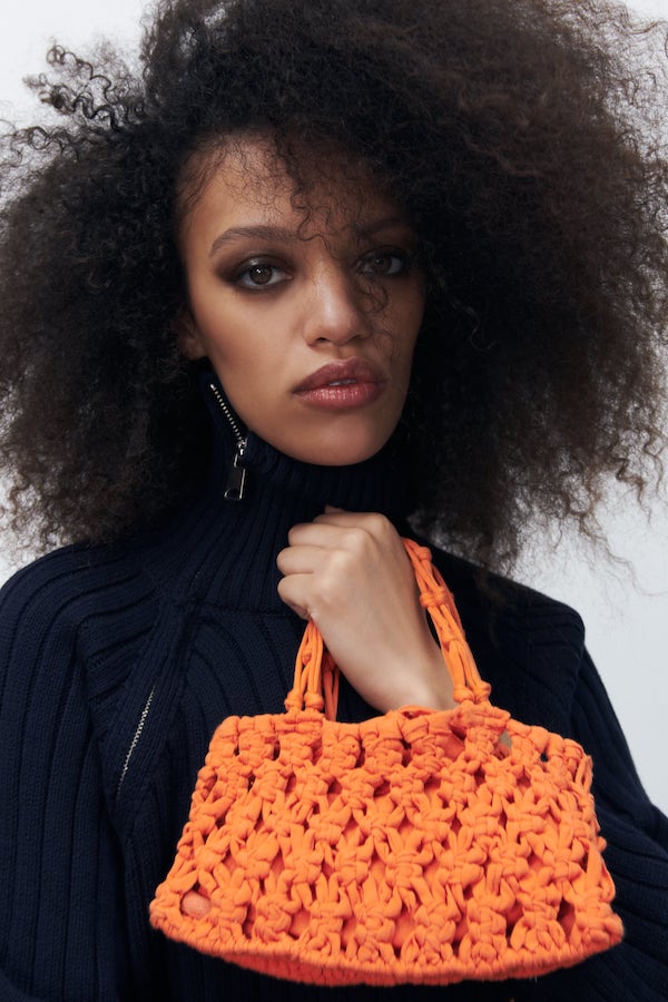 woman holds crochet bag from zara