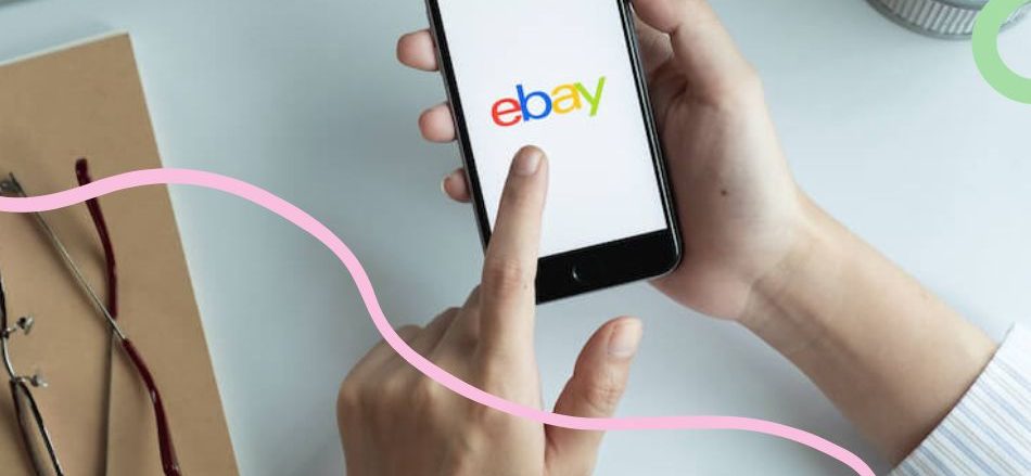 hand holds phone with ebay app loaded