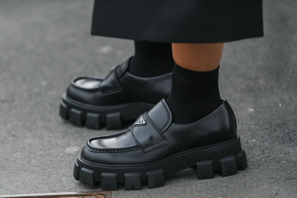 Woman wears chunky Prada loafers