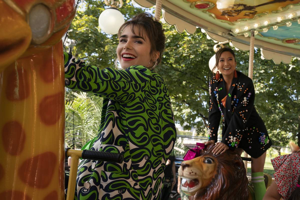 Emily in Paris. (L to R) Lily Collins as Emily, Ashley Park as Mindy in episode 304 of Emily in Paris. Cr. Stéphanie Branchu/Netflix © 2022