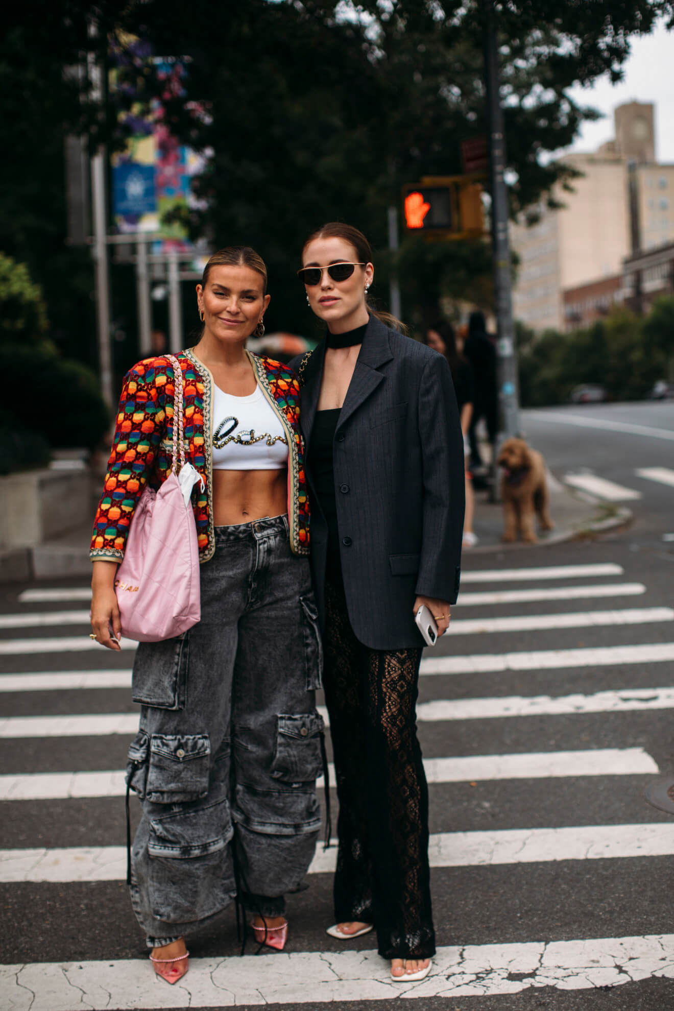 Two women at New York Fashion Week in cargo jeans and lace trousers