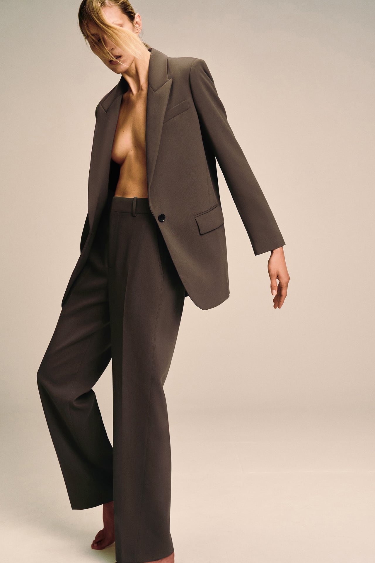 woman wears brown zara suit