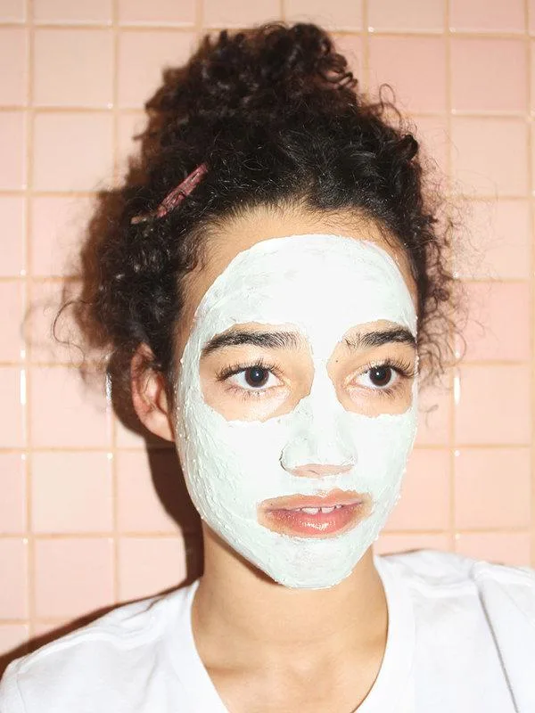 woman with Glossier mega greens galaxy pack facemask on