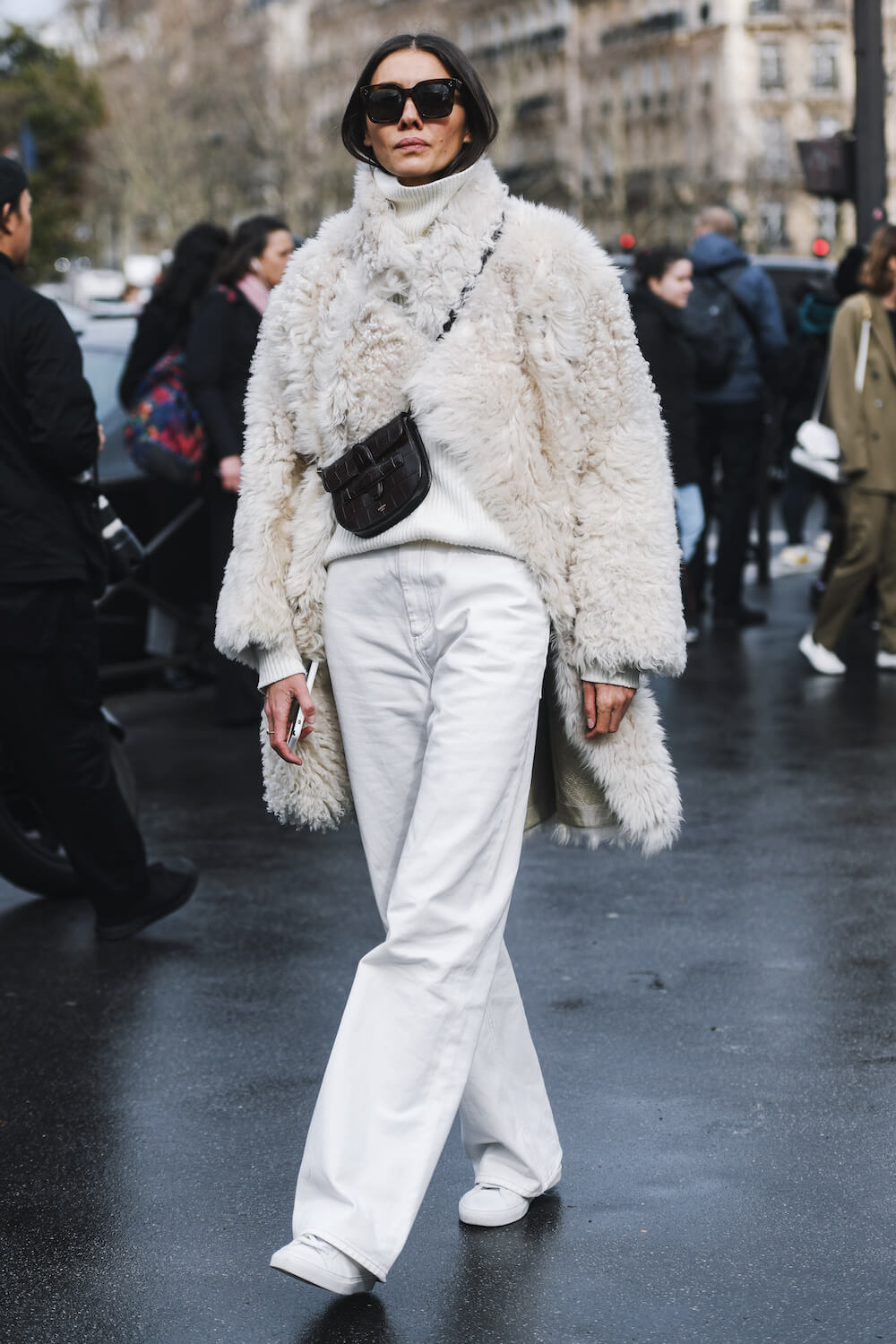 Woman wears faux fur coat and jeans 