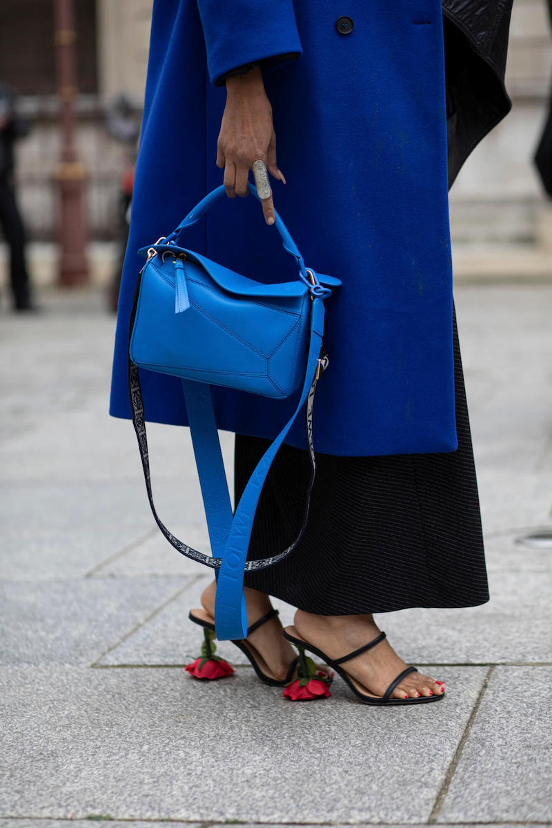 Woman wears loewe puzzle bag at london fashion week